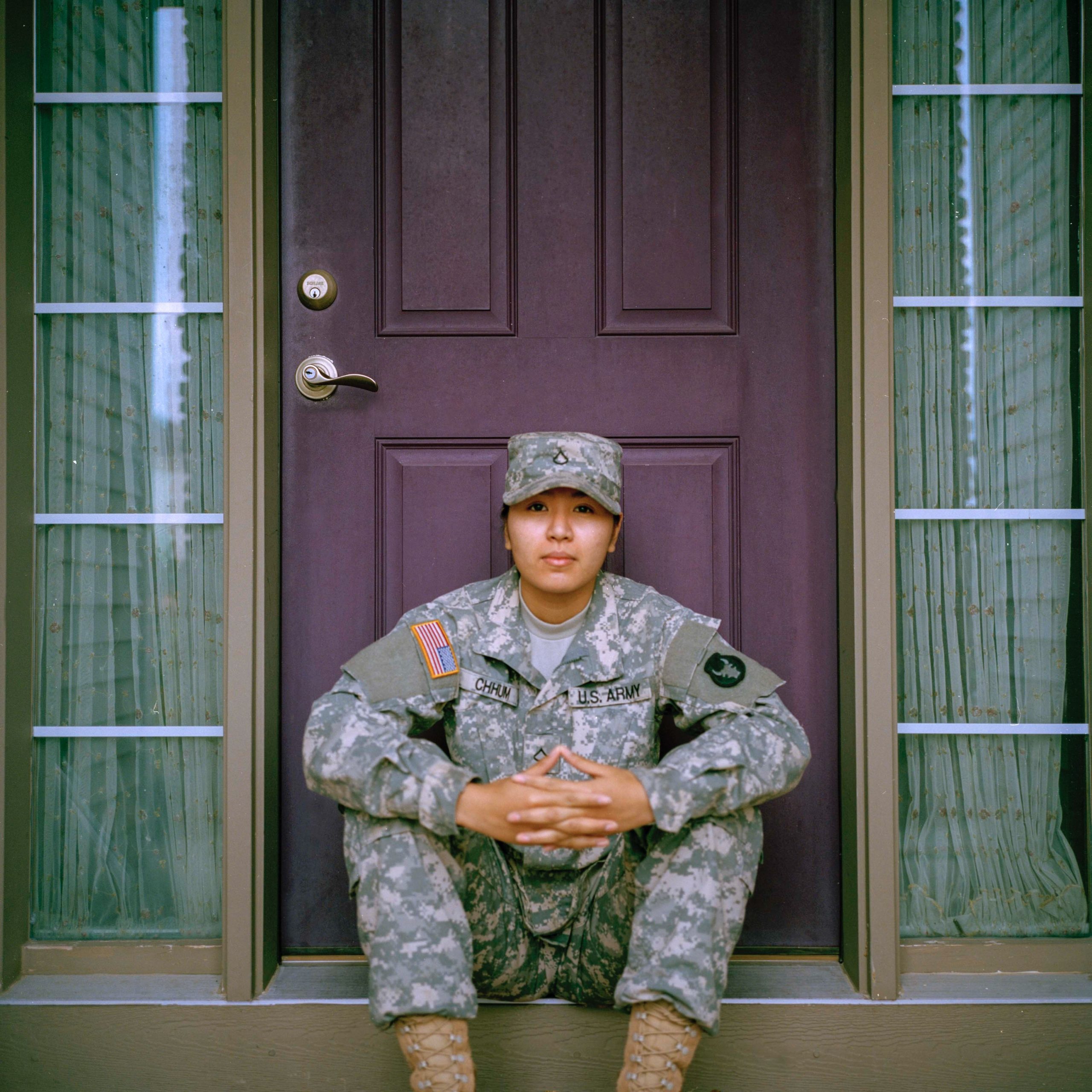 United States military member sitting on home front step